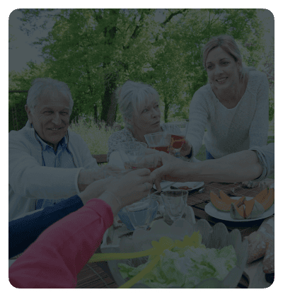 Group toasting at an outdoor meal.