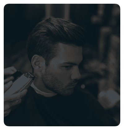 Man receiving a professional haircut at a barber shop.